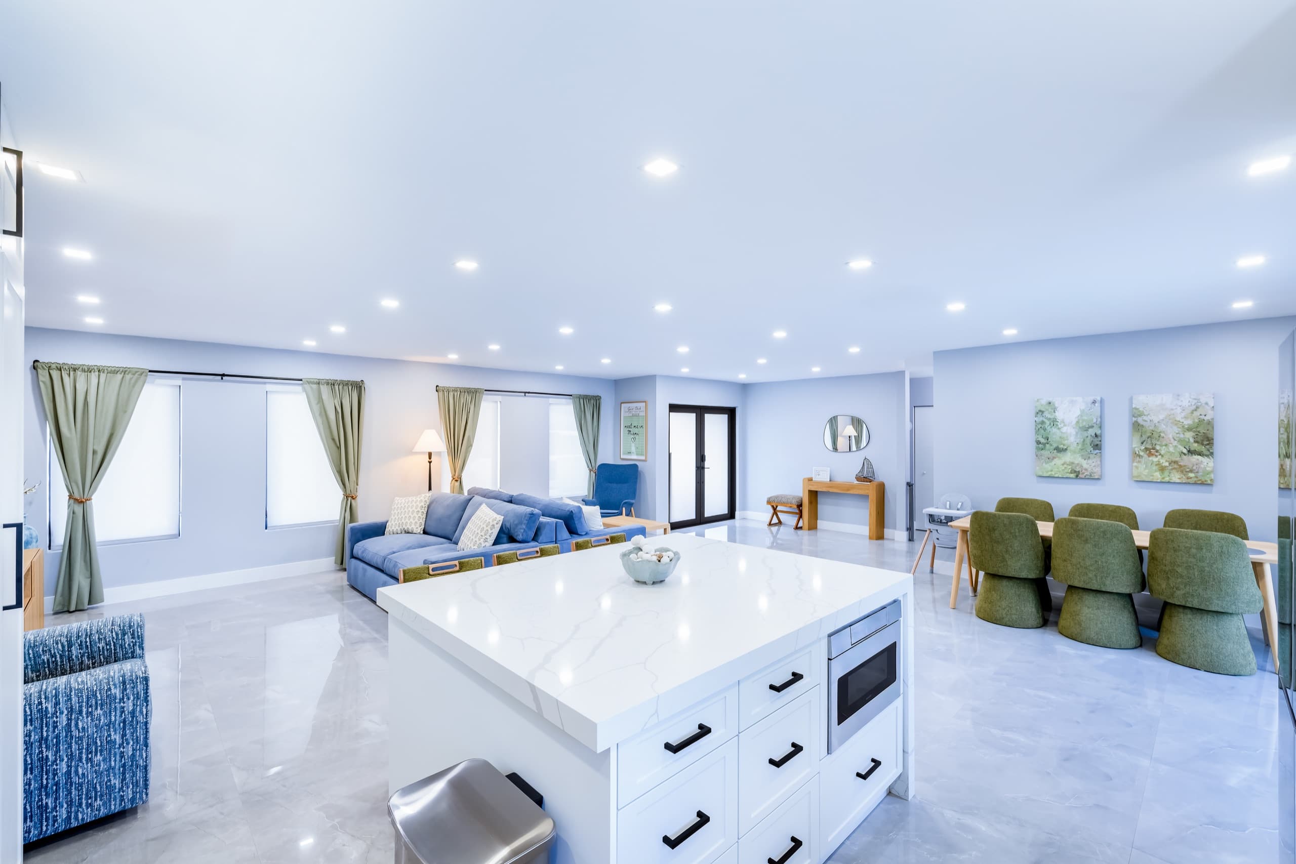 Kitchen island with a built-in microwave, looking back toward the living and dining areas.