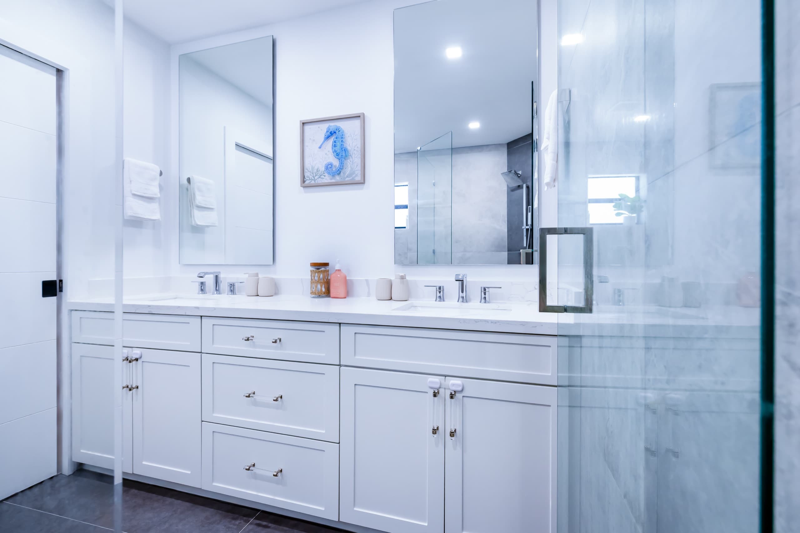 Double vanity seen through the shower glass.